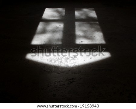 White arrow and cross shapes created by shadow from window.