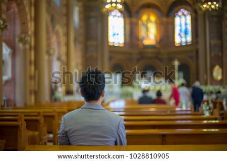 Asian man praying in church