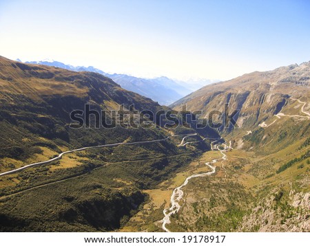 mountain scape with road and river visible in the valley