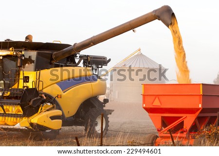 Wisconsin, USA - September 25, 2012:  Uploading corn from a harvester combine to a trailer truck