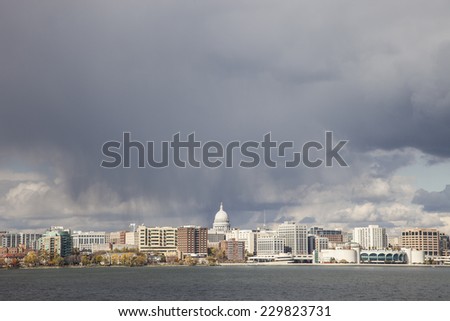 Madison, Wisconsin, USA - October 27, 2011: Madison, WI cityscape, storm clouds and Lake Monona in foreground.