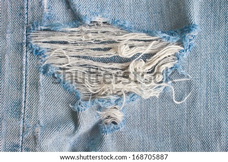 Blue torn denim jeans texture, close up texture