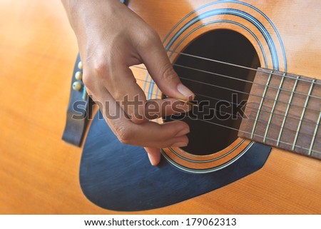 girl hand playing acoustic guitar, Close up of guitarist hand playing acoustic guitar
