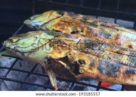 Cooking of salted fish on a grill stove