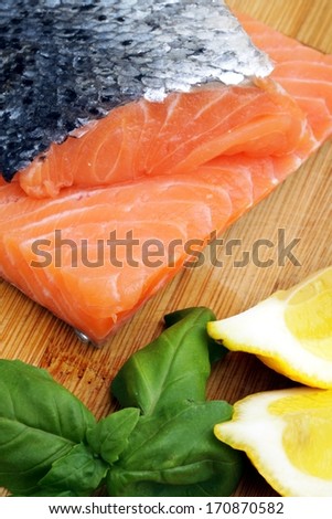 raw salmon, photo on the board with lemon basil and pepper