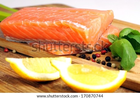 raw salmon, photo on the board with lemon basil and pepper