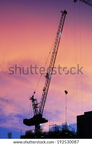 Cranes and Construction Site silhouette at twilight time