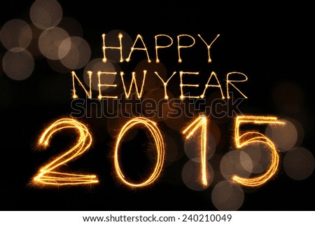 Happy New Year 2015 sparkle firework writing with unfocused dirty colorful light blur bokeh background
