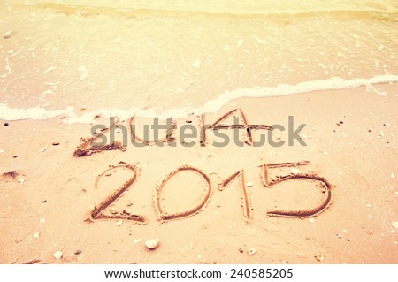 Year 2015 Coming writing on the beach Vintage tone