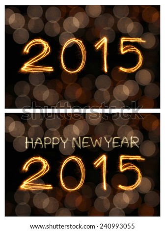 Happy new year 2015 writing sparkles firework with dirty defocused light blur bokeh background