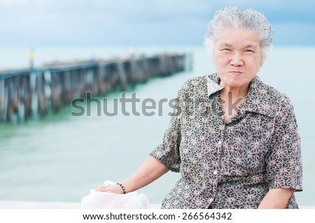 Portrait of asian grandma smile happiness with sea background