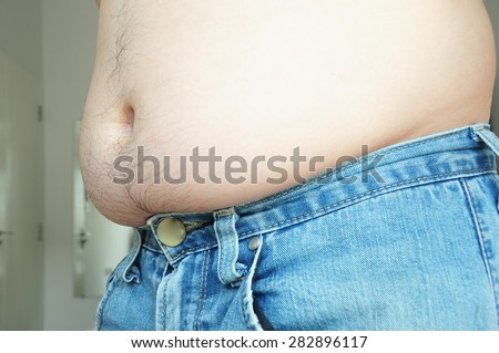 Fat man with a big belly wearing jeans