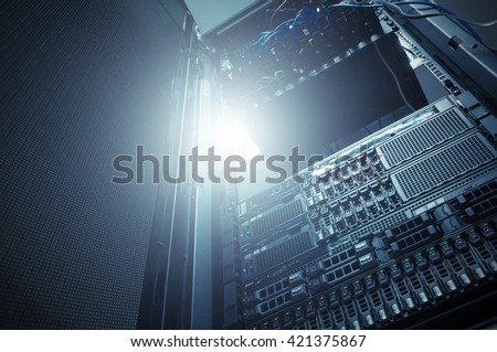 Bottom view of rack server against neon light in data center with dept of field