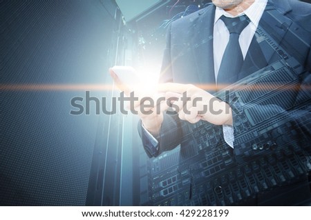 Double exposure of professional businessman using smart phone with servers technology in data center and network connection in IT Business technology concept