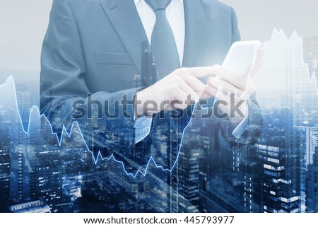 Double exposure of professional businessman connect internet smart phone and cityscape of business centre with international world financial graph, Business , finance , trading and banking concept