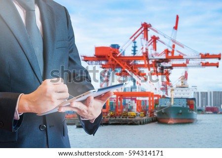 Double exposure of businessman touching tablet for analyze and checking stock at logistics port background, transportation trading business concept, world map element of this image furnished by NASA