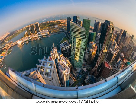 Fish-eye view of Singapore city skyline at sunset.