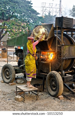 Woman working on the street, India.