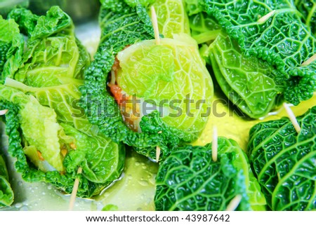 Roll of Savoy Cabbage with fish and tomato.
