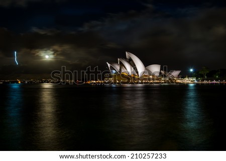SYDNEY Full Moon - August 12: The Sydney Opera House, viewed from Mrs Macquarie\'s Chair in Sydney, Australia, on August 12, 2014, was designed by Danish architect Jorn Utzon.
