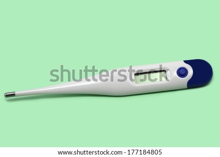 electronic medical thermometer on green background