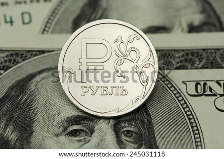coin one ruble on a background of US dollars background