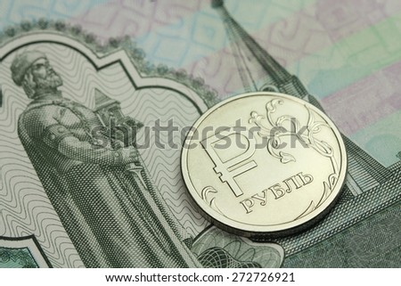 coin in one Russian ruble banknote thousand rubles background