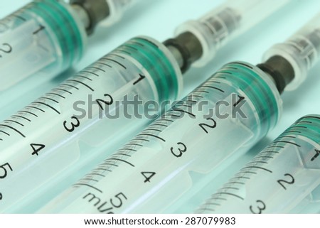 some disposable syringes on a blue background