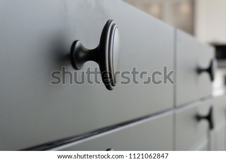 Black handles vintage style on black kitchen wooden cabinets
