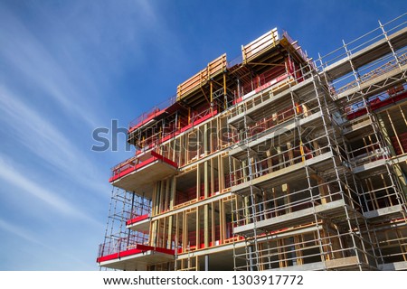 Construction of reinforced concrete building with wooden wall studs - contemporary urban development concept