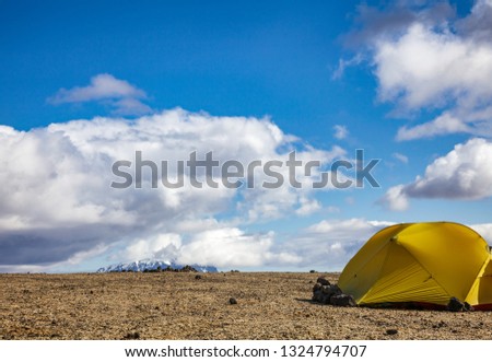 Camping tent on a rocky Dreki camping site near Askja caldera and Ódáðahraun lava field in Highlands of Iceland, Scandinavia. Herdubreid tuya volcano mountain is seen in background