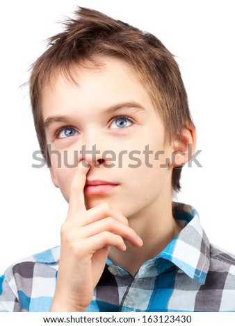 Portrait of dreamy boy picking his nose