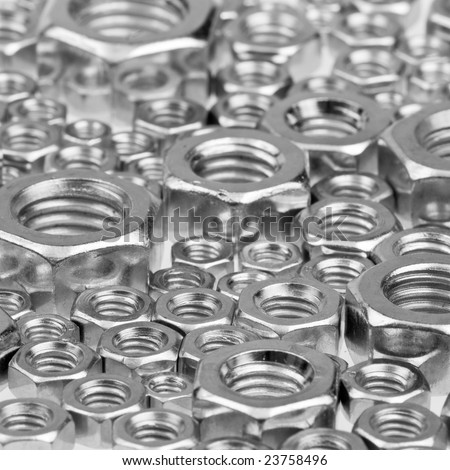 Assorted hex nuts background, selective focus