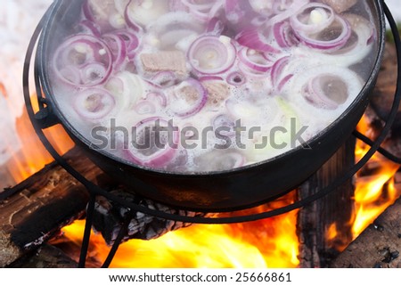 Cooking Chorba soup in cauldron  on fire
