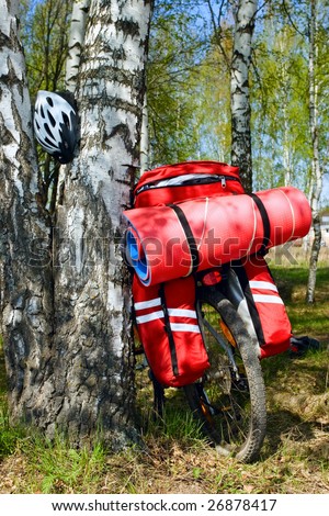 Loaded touring bicycle and helmet on rest break