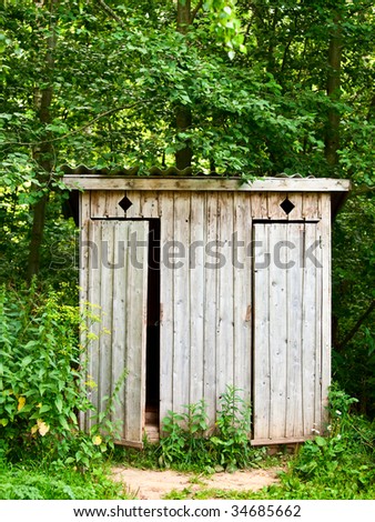 Old wooden outhouse in the forest