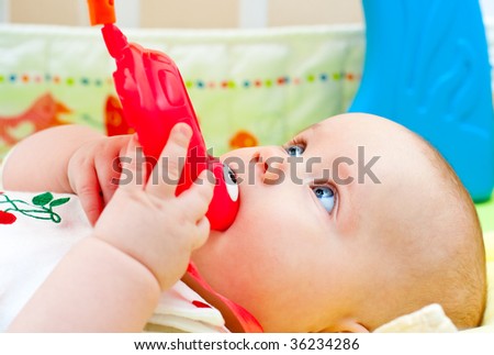 Little baby girl playing with teething toy
