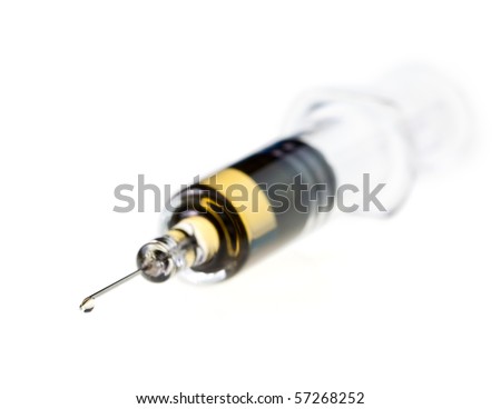 Medical syringe needle with yellow fluid on white background, very shallow focus