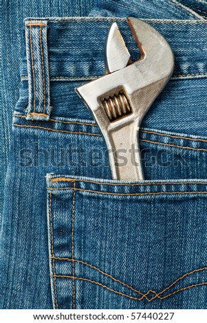 Blue jeans pocket with old adjustable spanner