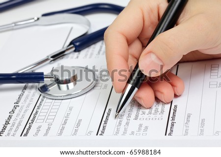 Hand with pen over blank Prescription form with patient information