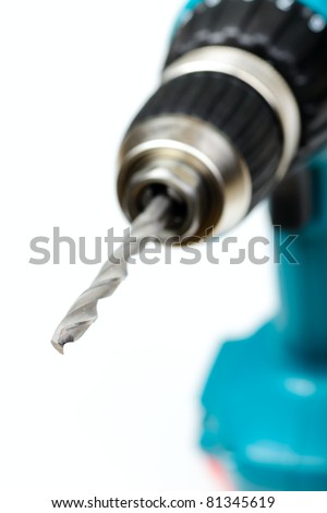 Cordless drill with twist drill bit on white background shallow focus