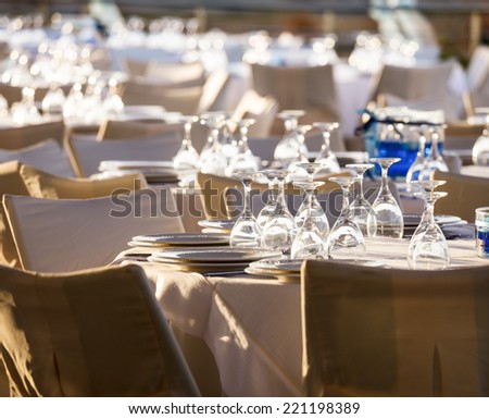 Table setting for an event party at outdoor cafe in the evening light
