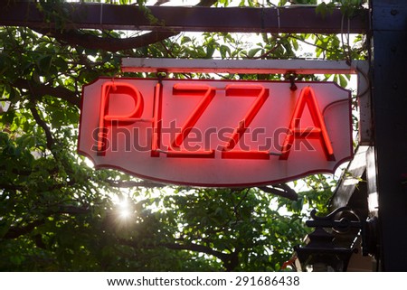 Glowing neon Pizza sign at a pizzeria