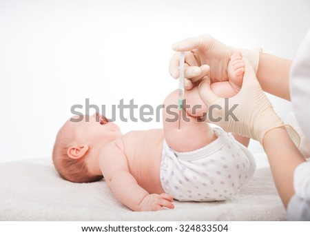 Close-up shot of pediatrician giving a three month baby girl  intramuscular injection in leg