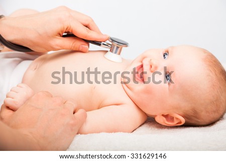 Close-up shot of pediatrician examines three month baby girl. Doctor using a stethoscope to listen to baby\'s chest