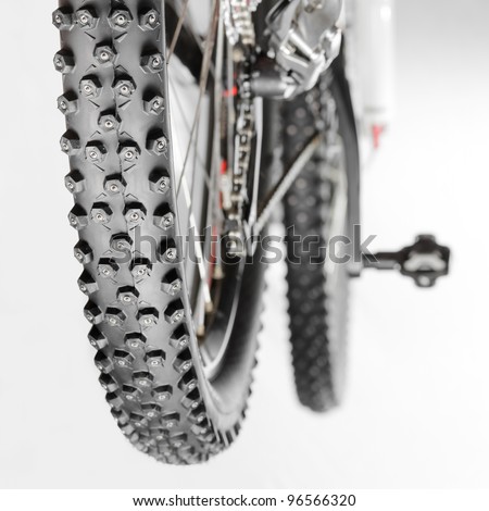 Knobby winter tire with spikes on a mountain bike close-up