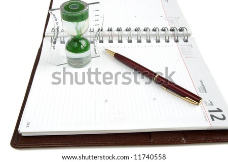 Concept time management, isolated diary, clock and pen on a white background