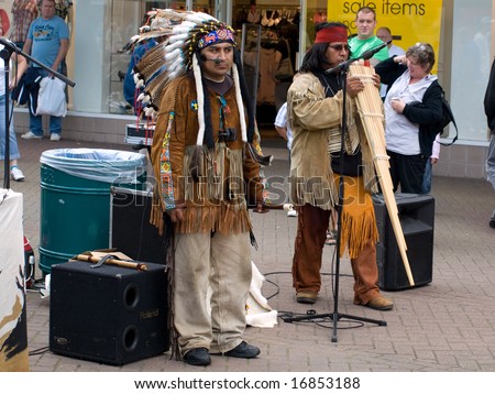 SKEGNESS, ENGLAND - AUG 23: Native American Indian tribal group play music, sing and dance to entertain shoppers in Skegness, England on 23 Aug 2008
