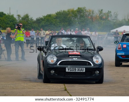 GRIMSBY, ENGLAND - JUNE 21: Stunt car driver Russ Swift entertains the crowds in his Mini Cooper at the New Mini Day, Manby Park,Grimsby in aid of Help For Heroes Charity, June 21st 2009