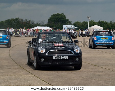 GRIMSBY, ENGLAND - JUNE 21: Stunt car driver Russ Swift entertains the crowds in his Mini Cooper at the New Mini Day, Manby Park,Grimsby in aid of Help For Heroes Charity, June 21st 2009